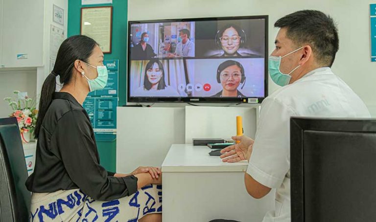 Asian doctor providing telehealth services to international patient (1)